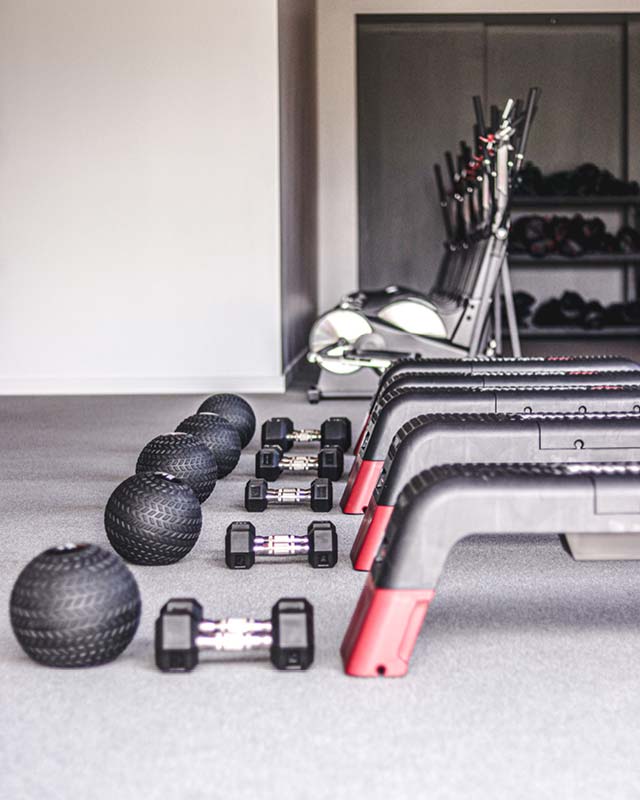 Weighted balls and dumbbells neatly set up in the Formula3 studio