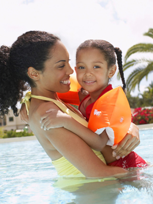 Woman and child swimming in the outdoor pool