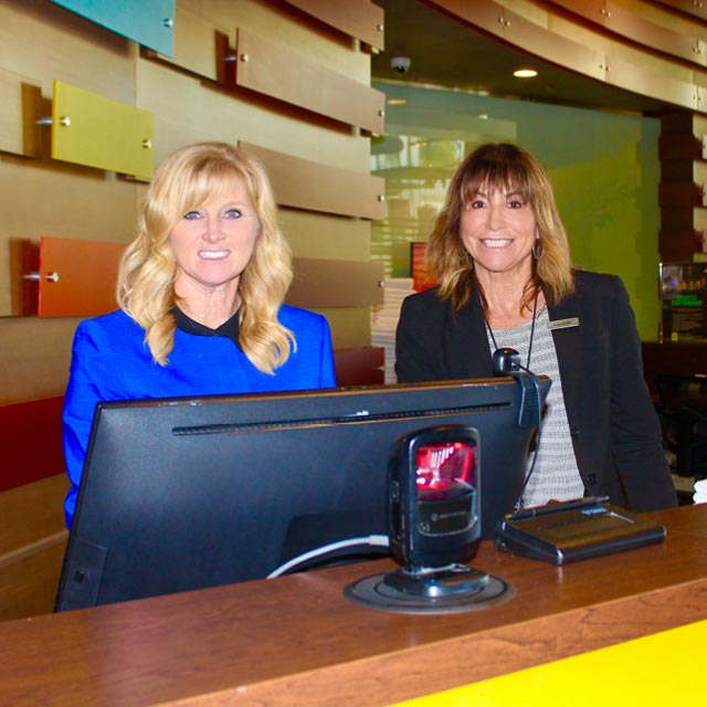 ClubSport employees working at the front desk in management positions