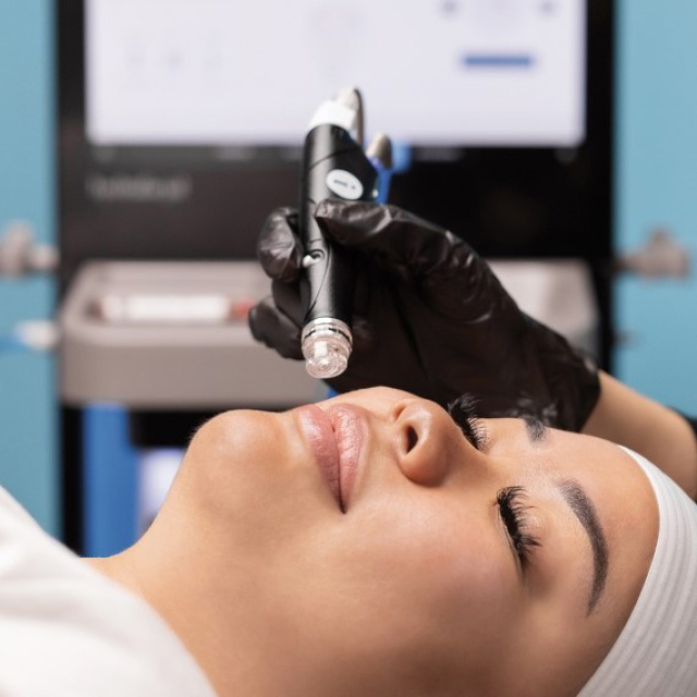 Woman lying on her back getting a Hydrafacial treatment at R Spa
