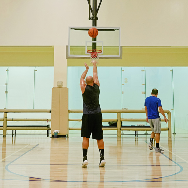 Man shooting baskets on the basketball court