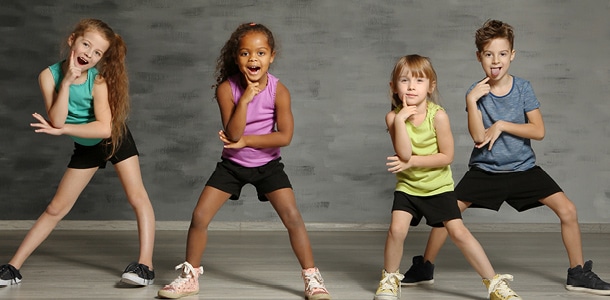 4 kids posing during a hip hop dance class
