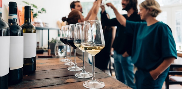 A group of people doing a wine tasting event