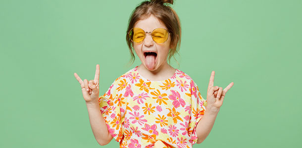 A little girl rocking out at a Rock 'n Roll themed Parents' Escape