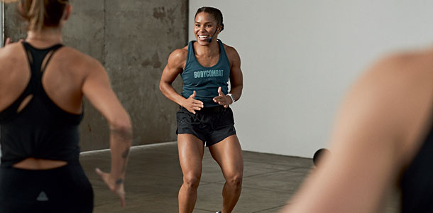 Female BODYCOMBAT instructor teaching a Les Mills format group fitness class at the Les Mills Launch Party