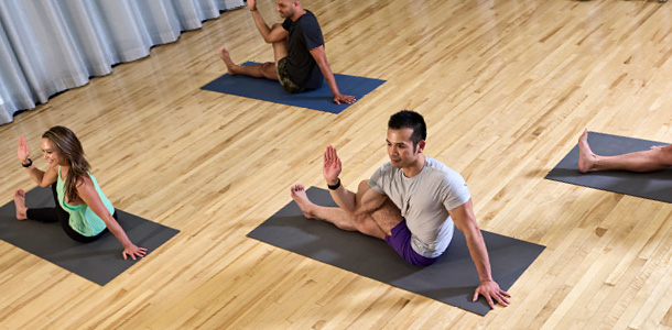 ClubSport members in a Restore & Realign Yin Yoga class with live healing music