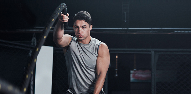 A man working out using battle ropes
