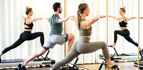 Members in a Pilates Reformer Sculpt class
