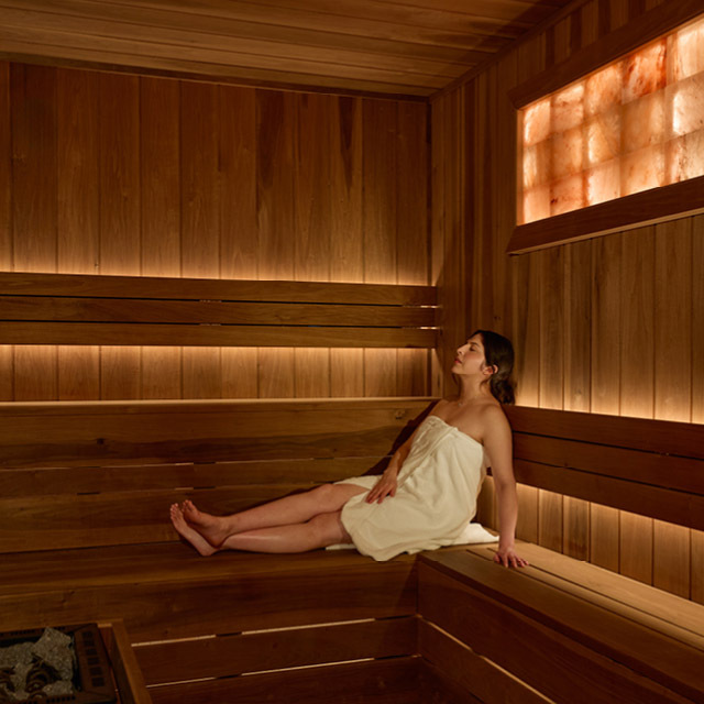 One woman enjoying the dry sauna with Himalayan salt wall